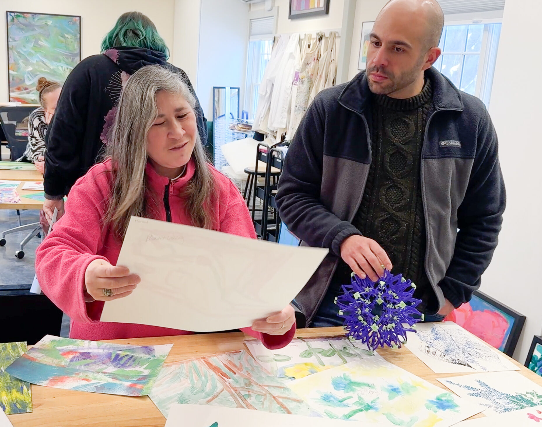 Kellie curates a piece while talking with Jeff Gagnon (Program Director).